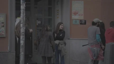 Young people waiting in front of a building in Madrid, Spain Video stock 345030852