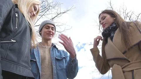 Young people walk in the park, tell the news, communicate, laugh. Good mood. Put Stock Footage