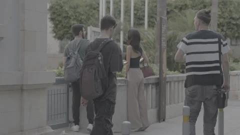 Young people walking along the roadside in Paphos, Cyprus Stock Footage 344056631