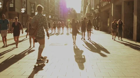 Young people walking down street at sunset in Munich Stock Footage
