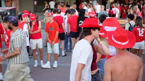 Young people walking, hugging in street, July 1, 2025,  Kelowna BC, Canada Stock Footage 312584450