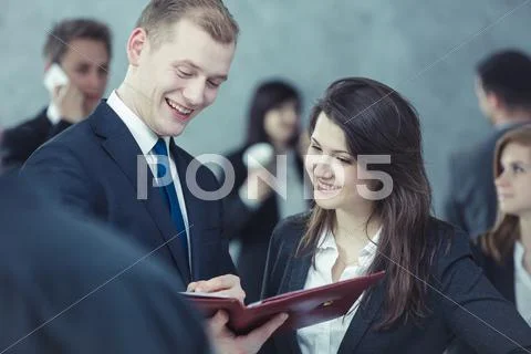 Young people watching the newspaper Stock Photos