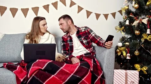 Young people work with their devices under a warm blanket next to their Stock Footage 150401844