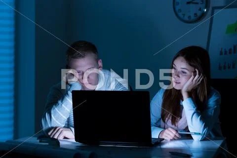Young people working overtime Stock Photos
