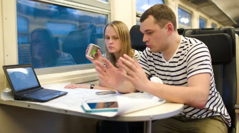 Young people working with plan in the train Vidéo 39797465