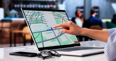 Young Person Browsing Local Map Pins On Laptop To Find Property. Stock Photos