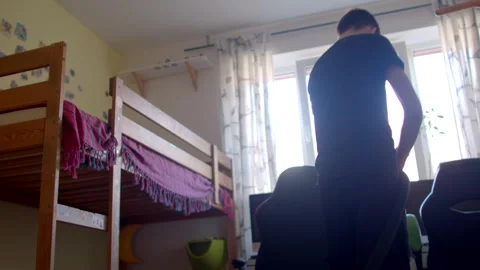 A Young Person Engaging in Cleaning Their Room Using a Vacuum Cleaner Stock Footage 311206339