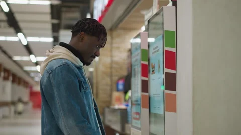 Young Person Interacting with Self-Service Kiosk in Food Court at Mall Video stock 316651418