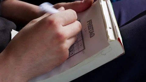 Young person playing sudoku Stock Footage 307019161