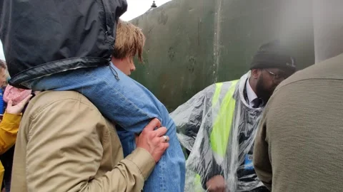 YOUNG PERSON ON SHOULDERS OF BOY TRYING TO SEE CHARLES CORONATION 6 MAY 2023 4K Stock Footage 240492011