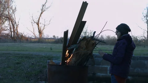 Young Person Tending Trash Can Fire in Rural Tennessee USA BMPC4K Video stock 234753353