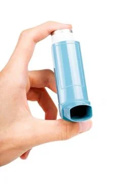 Young person using a blue pocket asthma inhaler holding it in hand front view Stock Photos