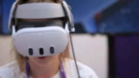 Young person using virtual reality gear at tech expo or gaming event Stock Footage 345038423