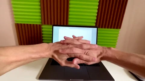 Young person, a writer or programmer, sits down at a computer and writes a text Stock Footage 238031110