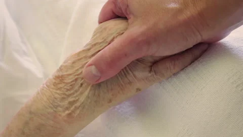 Young person's hand holding old woman's hand Vídeo Stock 321382490
