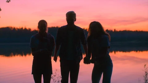 Young persons under the confetti rain at sunset Stock Footage 98947232