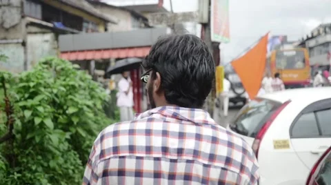 Young perspective indian man walking through city Stock Footage 60004252