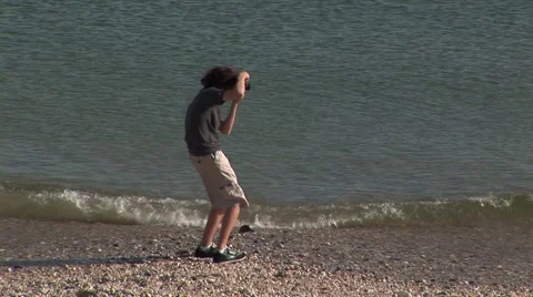 Young Photographer on beach Stock Footage 55301796
