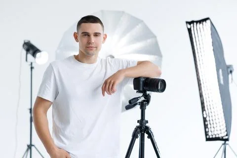Young photographer in the process of shooting in the Studio Stock Photos