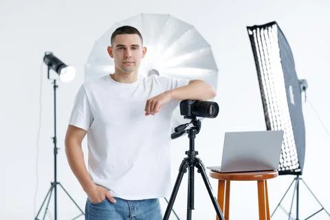 Young photographer in the process of shooting in the Studio Stock Photos