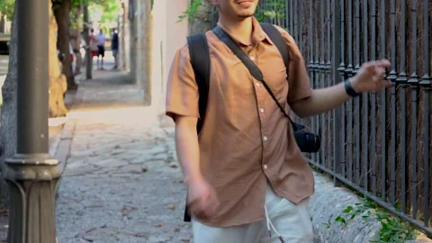 Young photographer walking Stock Footage 282575991
