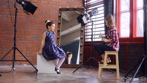 Young photographer working with a young model Video stock 105036508
