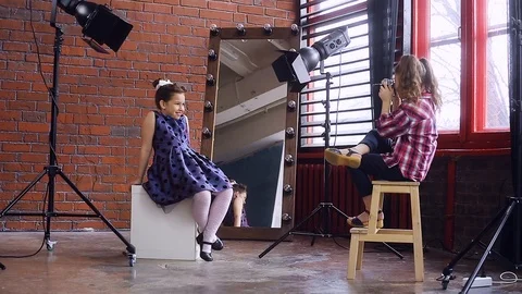 Young photographer working with a young model Video stock 105036896