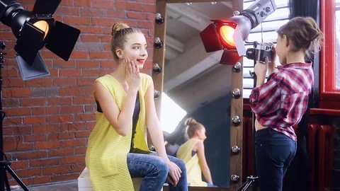 Young photographer working with a young model Video stock 105038196
