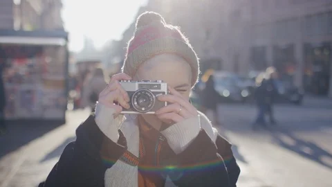 Young photography student using a retro film camera to take a photo of the viewe Video stock 122227784