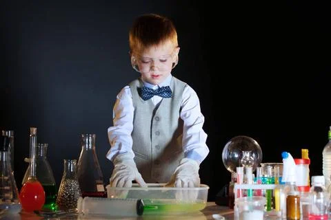 Young physicist experimenting with the reagents Image of young physicist e... Stock Photos
