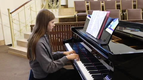 Young pianist practices skillfully in elegant music hall setting Stock Footage 297398908