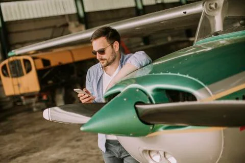 Young pilot checking ultralight airplane before flight Stock Photos