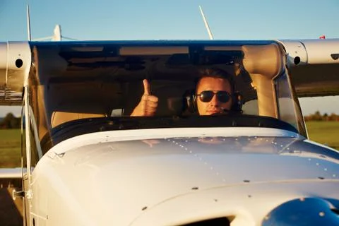 Young pilot is preparing for take off with private plane. 写真素材