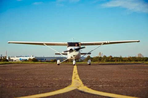 Young pilot is preparing for take off with private plane. Stock Photos