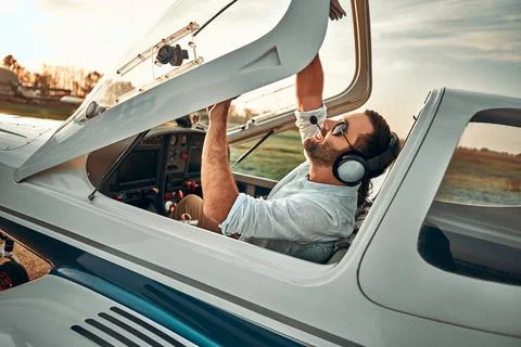 Young pilot is preparing for take off with private plane Фото