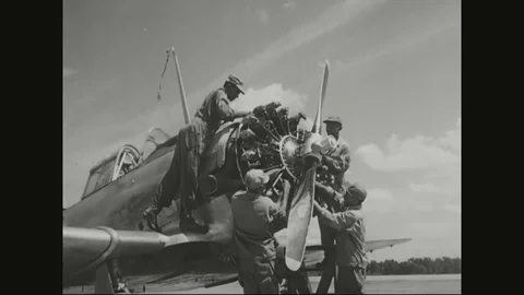 Young pilots repair and learn to fly a double winged airplane - 1940-1970 Stock Footage 83830492