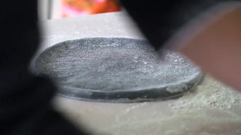 A young pizza maker prepares pizza in the kitchen of the restaurant. Mix the Stock Footage 84829387