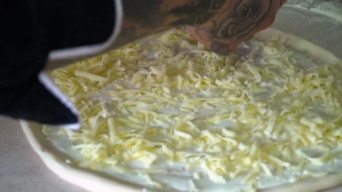 A young pizza maker prepares pizza in the kitchen of the restaurant. The cook 스톡 동영상 84829758