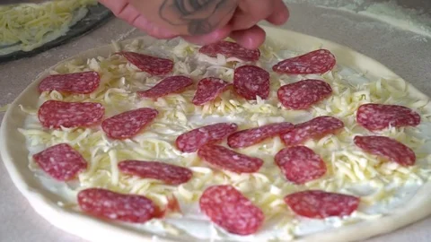 A young pizza maker prepares pizza in the kitchen of the restaurant. The cook Stock Footage 84829808