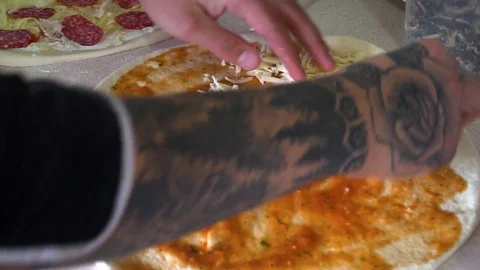 A young pizza maker prepares pizza in the kitchen of the restaurant. The cook Stock Footage 84829900