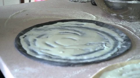 A young pizza maker prepares pizza in the kitchen of the restaurant. Prepares Video stock 84831699
