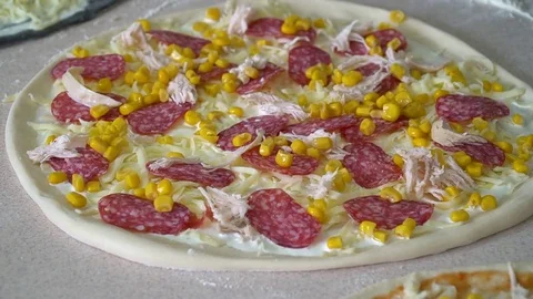 A young pizza maker prepares pizza in the kitchen of the restaurant. The cook Stock Footage 84831768
