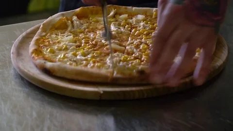 A young pizza maker prepares pizza in the kitchen of the restaurant. The cook Stock Footage 84831982
