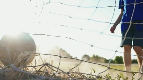 The young player rolls the ball into the net. Training day. Shots on goal. Stock Footage 154094540