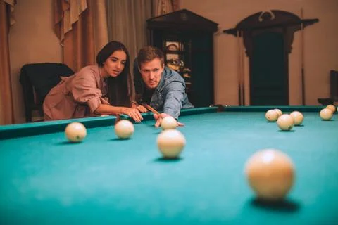 Young player stand in angled position and aiming to break ball. He looks Fotos Stock
