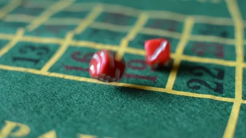 Young player using red dice on a green casino table Video stock 201410690