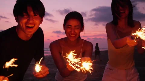Young playing firework with sunset background. Stock Footage 184270206