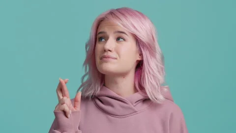 Young pleading cute hipster student girl pastel pink hair keeping finger crossed 스톡 동영상 220110089