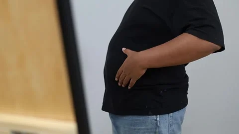 Young plus-size Asian man standing in front of mirror, fat body concept Stock Footage 342283097