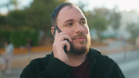 Young plus size man smiling confident talking on the smartphone at park Video stock 171816665